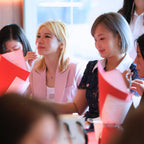 Group of women sitting together, attending a perfume making workshop